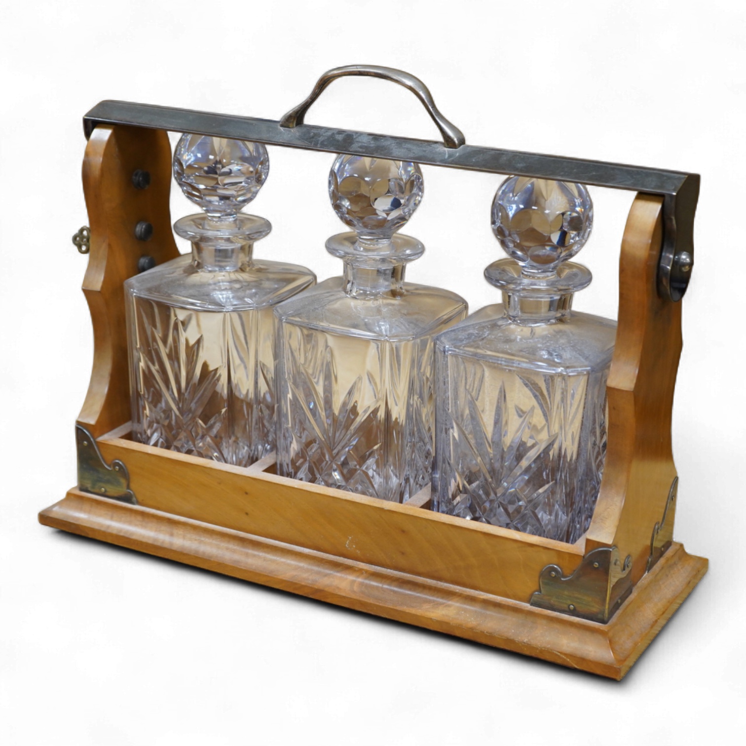 A walnut three-decanter tantalus, 41cm
